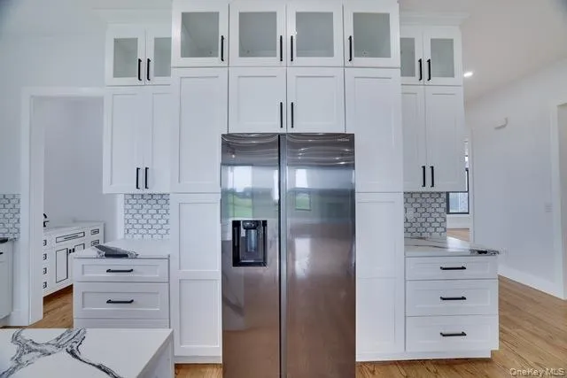 a kitchen with a refrigerator and cabinets