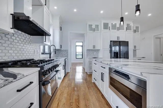 a kitchen with stainless steel appliances a sink stove and cabinets