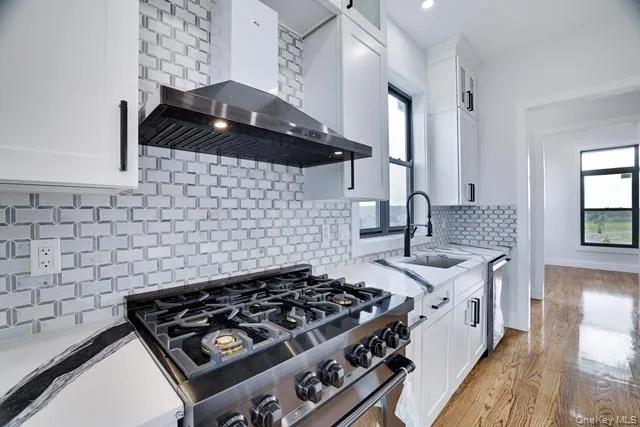a kitchen with a stove a sink and a stove