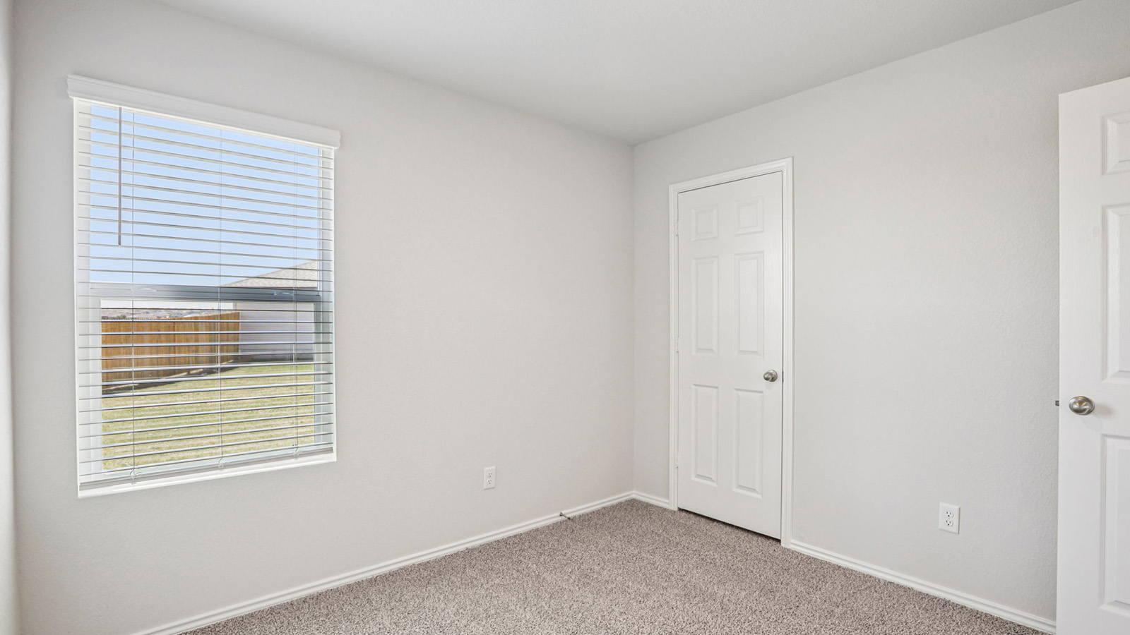 148 Wyatt Way Jarrell, TX 76537 - Photo 30 of 33 Bedroom with light gray walls, textured carpet flooring, and a window with horizontal blinds