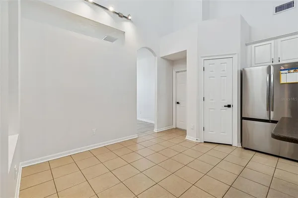 a kitchen with granite countertop a sink stainless steel appliances and white cabinets
