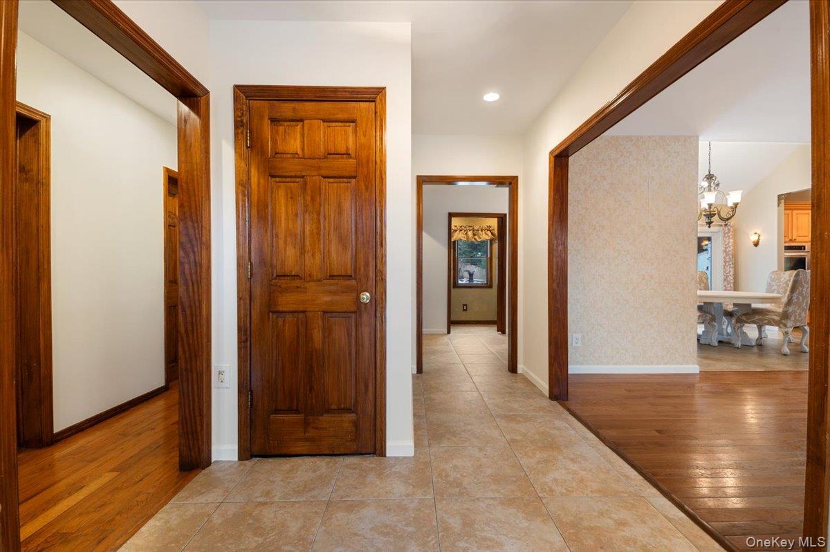 33 Fleets Cove Road Huntington, NY 11743 - Photo 6 of 42 Hallway featuring light wood-style floors, a chandelier, and recessed lighting