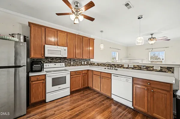 a kitchen with stainless steel appliances granite countertop a stove cabinets and refrigerator