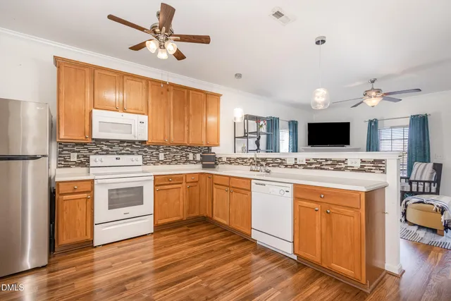 a kitchen with a stove a sink and a refrigerator