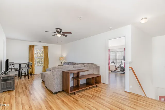 a view of living room with furniture and wooden floor