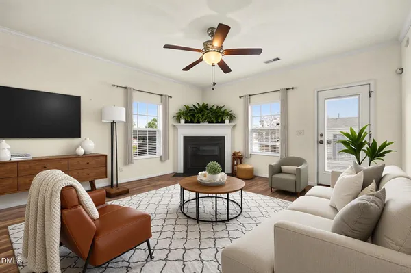 a living room with furniture a flat screen tv and a fireplace