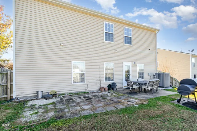a view of backyard of house with outdoor seating
