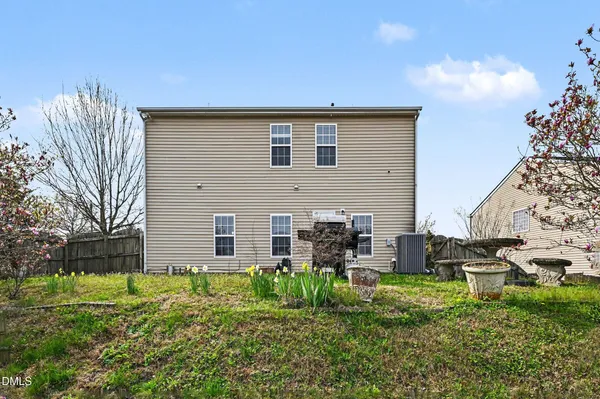 a backyard of a house with table and chairs