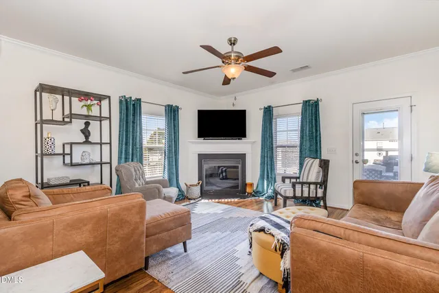 a living room with furniture a fireplace and a flat screen tv