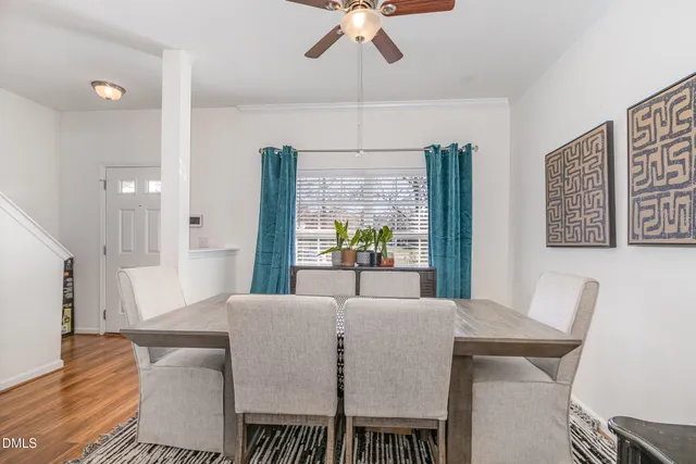 a view of a dining room with furniture and wooden floor
