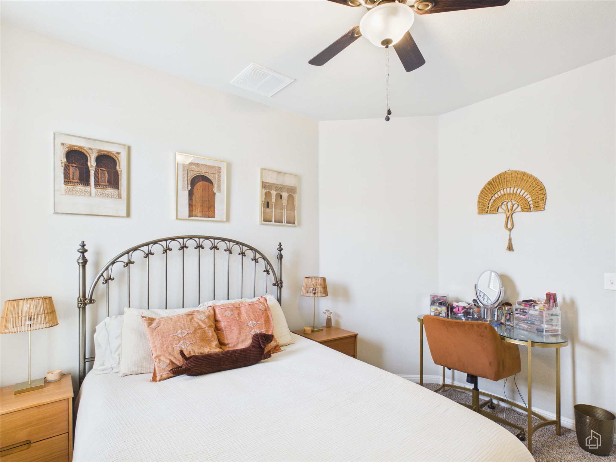 9310 Tanager Way Austin, TX 78748 - Photo 21 of 32 A well-lit bedroom features a classic metal bed frame and a practical ceiling fan for comfort.
