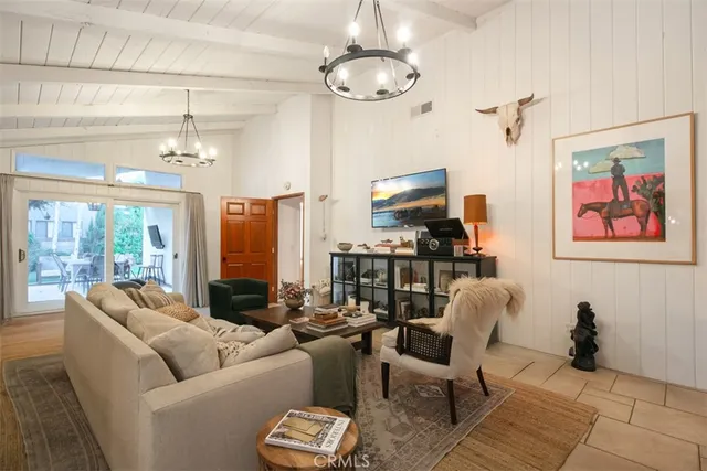 a living room with furniture fireplace and flat screen tv