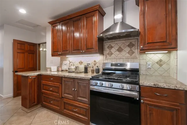 a kitchen with stainless steel appliances granite countertop a sink and a stove