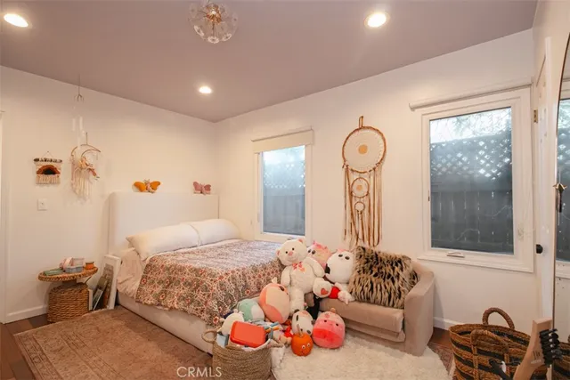 a bedroom with a bed with wooden floor