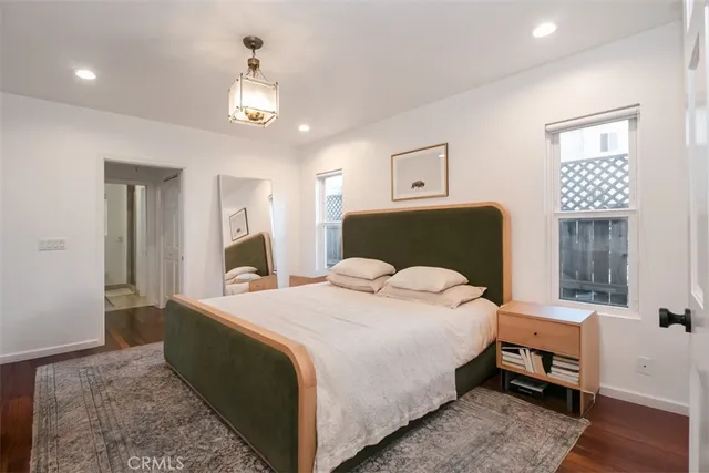 a bedroom with a large bed and a chandelier