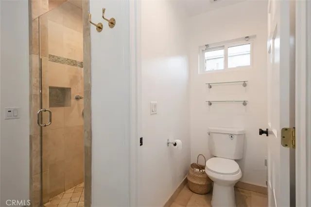 a room with a bed and a large window with wooden floor