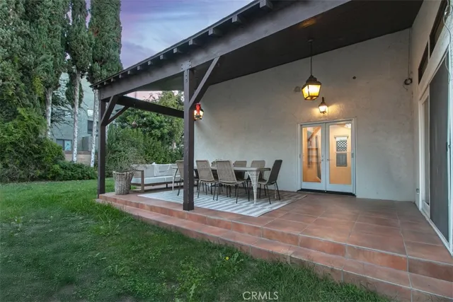 a view of a house with a yard and sitting area