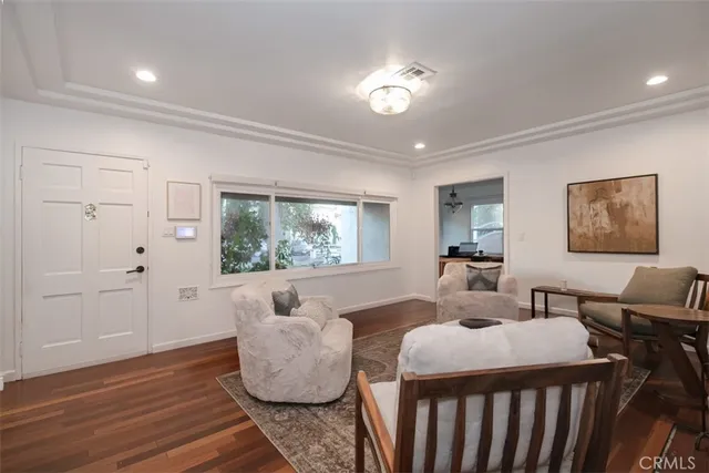a living room with furniture rug and window