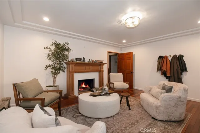 a living room with furniture a chandelier and a large window