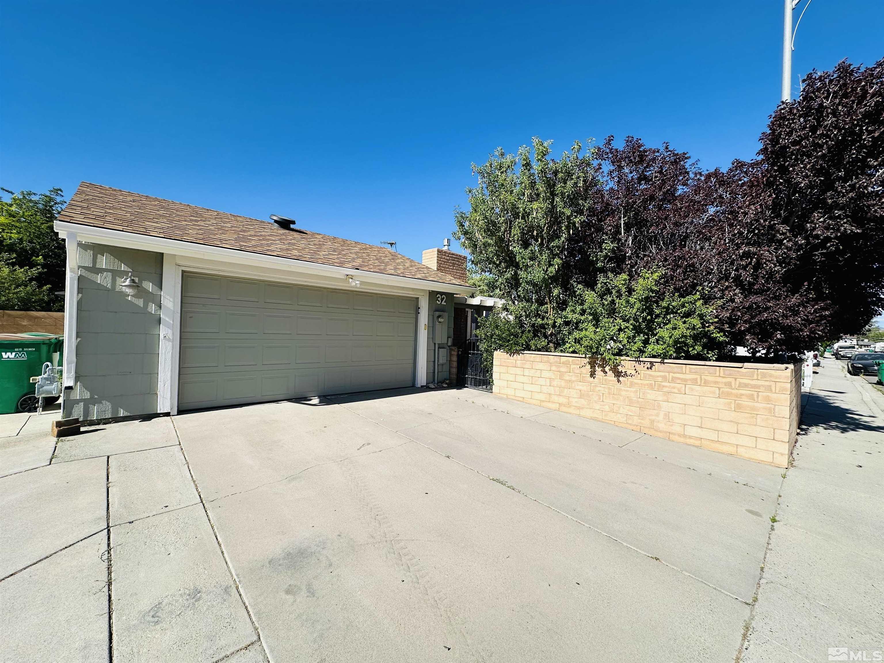 a view of house with yard and garage