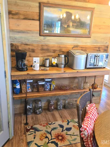 a bedroom with a bed and dresser with mirror