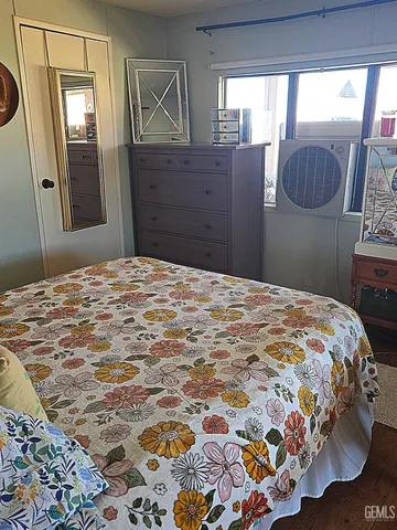 a bedroom with a bed and glass window