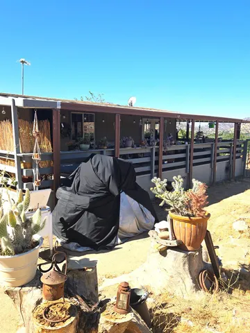 a view of a patio with couches and potted plants