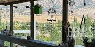 a front view of a building with table and chairs