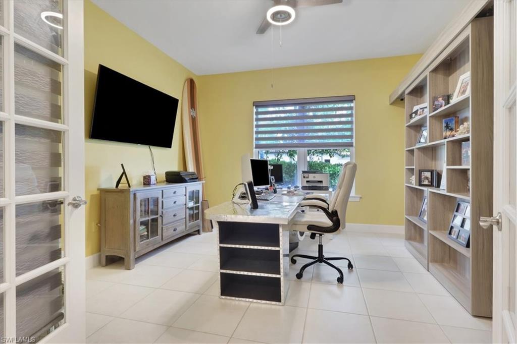 3221 Quilcene Lane Naples, FL 34114 - Photo 13 of 42 a view of a livingroom with workspace and a window