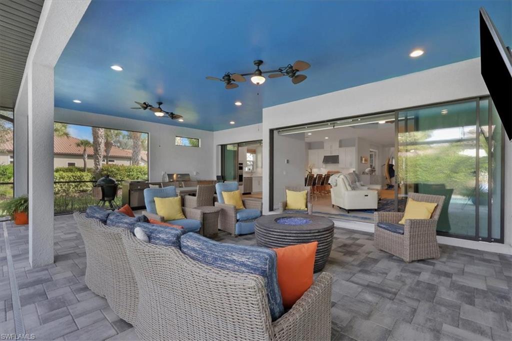 3221 Quilcene Lane Naples, FL 34114 - Photo 24 of 42 a view of a dining room with furniture wooden floor and a chandelier