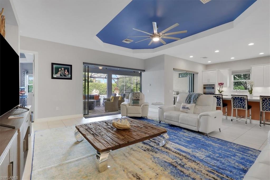 3221 Quilcene Lane Naples, FL 34114 - Photo 5 of 42 a living room with furniture and a flat screen tv