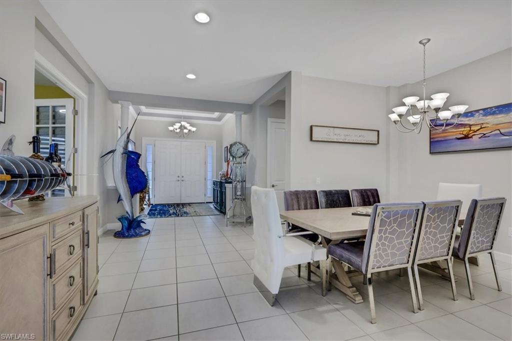3221 Quilcene Lane Naples, FL 34114 - Photo 8 of 42 a view of a dining room with furniture and chandelier