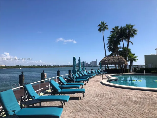 a view of a ocean with a bench and lake view