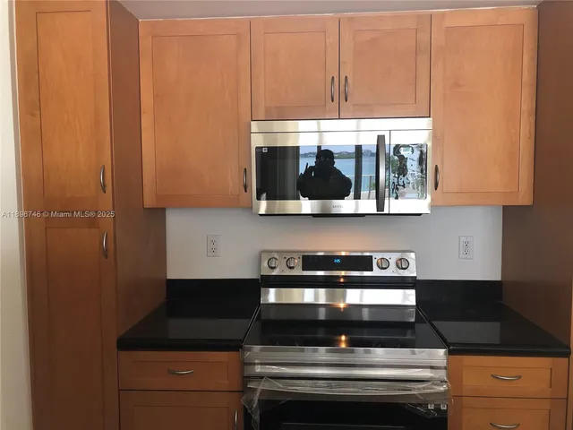 a living room filled with furniture and a large window