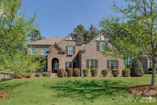 a front view of a house with a garden