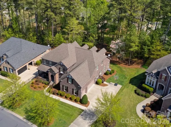 an aerial view of a house with swimming pool garden and patio