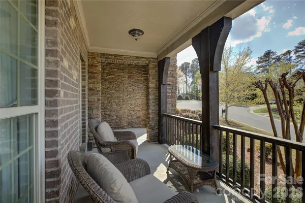 a view of a porch with furniture and a yard