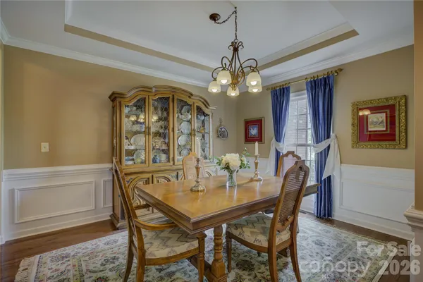a view of a dining room with furniture and a chandelier