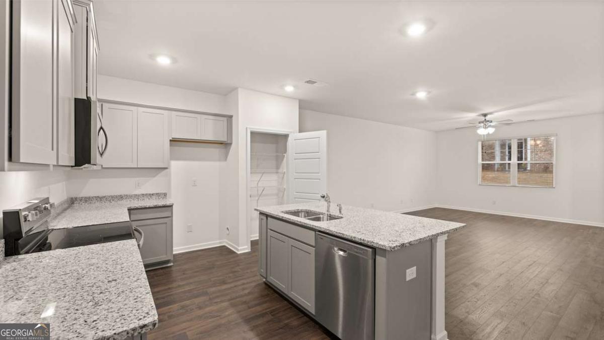 364 Sound Circle Stockbridge, GA 30281 - Photo 13 of 47 a kitchen that has a sink a stove and a refrigerator