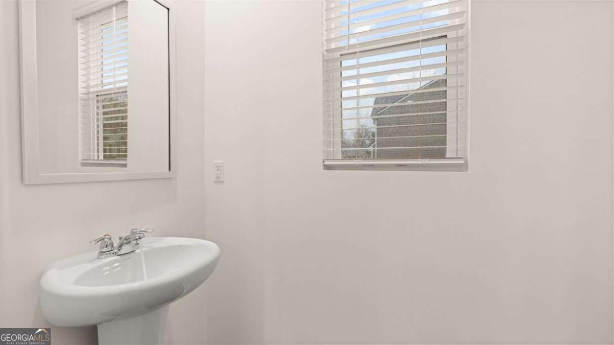 364 Sound Circle Stockbridge, GA 30281 - Photo 18 of 47 a bathroom with a sink and a mirror