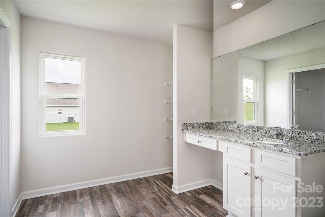 162 Brixham Loop Troutman, NC 28166 - Photo 6 of 6 a bathroom with a granite countertop sink and a mirror