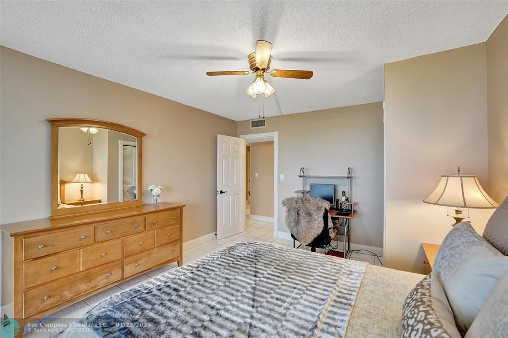 1600 South Ocean Drive, Unit 18B Hollywood, FL 33019 - Photo 16 of 36 a bedroom with a bed and a chandelier