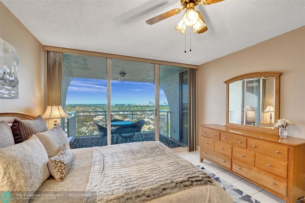 1600 South Ocean Drive, Unit 18B Hollywood, FL 33019 - Photo 18 of 36 a bedroom with a large bed and a chandelier