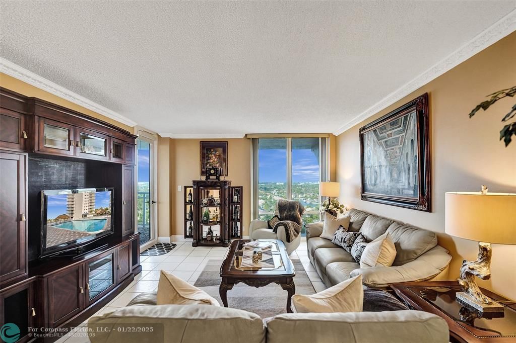 1600 South Ocean Drive, Unit 18B Hollywood, FL 33019 - Photo 6 of 36 a living room with furniture a flat screen tv and a fireplace