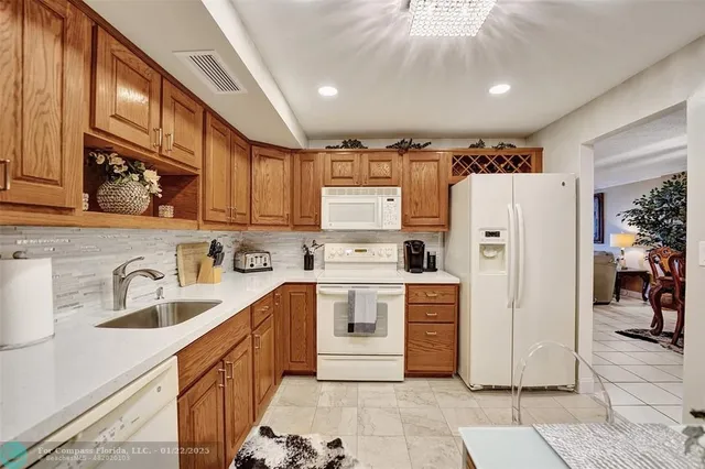 a kitchen with stainless steel appliances a refrigerator sink and cabinets