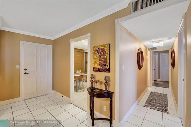 a view of a hallway to a livingroom with furniture and front door