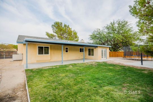 437 Emily Street Ridgecrest, CA 93555 - Photo 23 of 28 a front view of a house with a yard