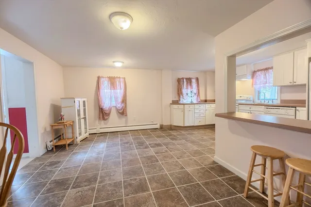 a view of a kitchen with fridge and window