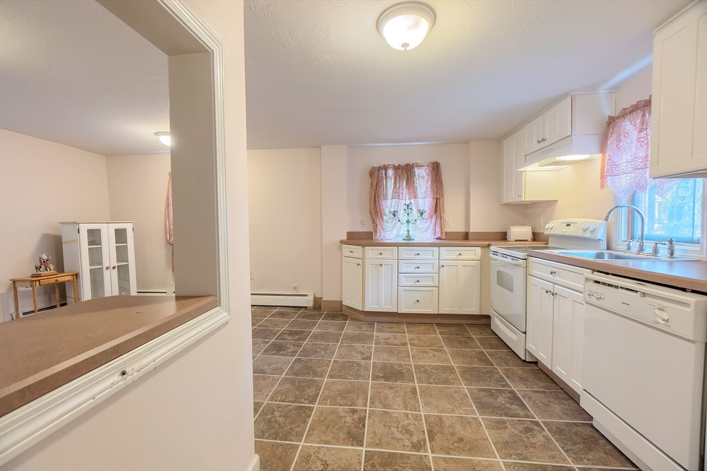 201 Stone Street Clinton, MA 01510 - Photo 17 of 42 a large white kitchen with a stove a sink dishwasher and a refrigerator