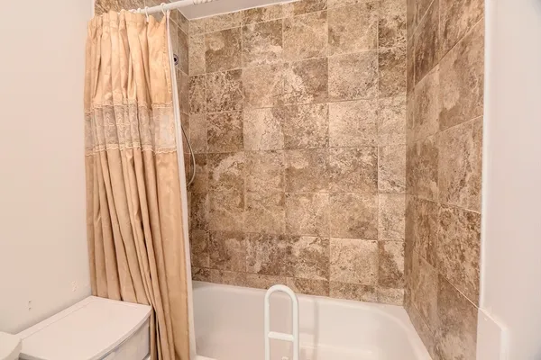a bathroom with a shower curtain and a sink